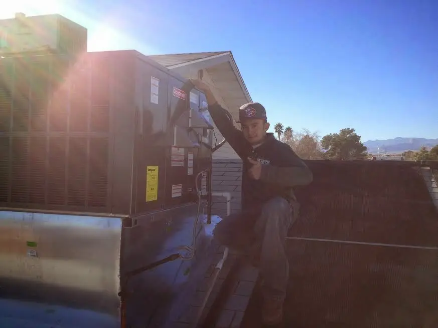 HVAC technician performing Air Duct Cleaning on a rooftop unit in Black Forest